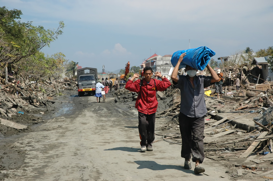 People walking on Dirt Road after an Environmental Disaster